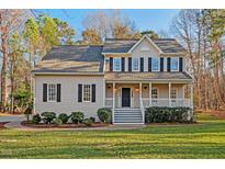 Charming two-story home with a welcoming front porch, manicured lawn, and inviting curb appeal at 300 Stonehill Rd, Chapel Hill, NC 27516
