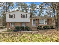 Charming two-story home featuring a brick facade, white siding, and well-maintained landscaping at 3108 Selkirk Pl, Raleigh, NC 27604