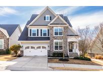 Charming two-story home with a two-car garage, stone accents, and a well-manicured lawn in a suburban neighborhood at 317 Daniel Ridge Rd, Wendell, NC 27591