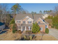 Charming two-story home boasts beautiful landscaping and inviting curb appeal at 3671 Coach Lantern Ave, Wake Forest, NC 27587