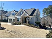 Charming two-story home with stone accents, gray siding, manicured lawn, and a well-kept landscape at 429 Teague St, Wake Forest, NC 27587
