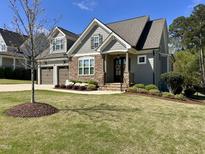 Charming home with a well-manicured lawn, stone accents, and a welcoming front porch at 429 Teague St, Wake Forest, NC 27587