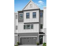 Charming two-story home featuring a gray two-car garage and a beautifully designed facade at 4507 Mint Leaf Ln, Raleigh, NC 27612