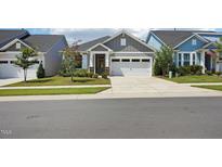 Charming single-Gathering home with neutral siding, well-manicured lawn, and attached two-car garage at 816 Still Willow Ln, Wendell, NC 27591