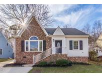 Charming brick home with manicured lawn and inviting entrance, perfect for a cozy Gathering living at 107 Kingsmill Rd, Cary, NC 27511