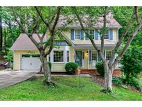 Charming yellow two-story home with blue shutters and a well-manicured lawn at 109 Reton Ct, Cary, NC 27513