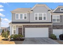 Charming two-story home with a two car garage, stone accents and manicured landscaping at 110 Cambria Ln, Morrisville, NC 27560