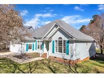 Charming single-Gathering home featuring light blue siding and teal shutters at 11113 N Radner Way, Raleigh, NC 27613