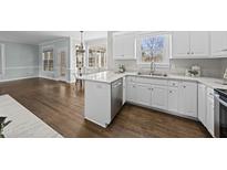 Bright kitchen with white cabinets, stainless steel appliances, and hardwood floors at 126 Claire Dr, Clayton, NC 27520