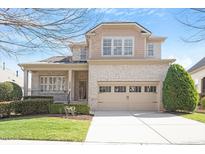 Charming two-story home with brick facade, attached garage and manicured landscaping, perfect for suburban living at 1324 Vanagrif Ct, Wake Forest, NC 27587