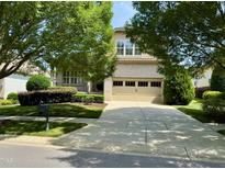 Charming two-story brick home with well-manicured lawn and inviting curb appeal at 1324 Vanagrif Ct, Wake Forest, NC 27587