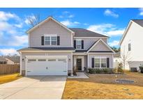 Charming two-story home with a well-manicured lawn, attached garage, and classic architectural details at 201 Imperial Dr, Clayton, NC 27527