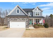 Charming two-story home with stone accents, a covered porch, and a well-manicured front lawn at 201 Northview Dr, Middlesex, NC 27557