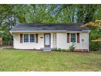Charming one-story home with a well-maintained lawn, cute shutters, and a welcoming front entrance at 2453 Derby Dr, Raleigh, NC 27610