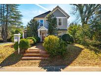 Charming two-story home with landscaped yard and inviting brick steps to the front porch at 319 W Margaret Ln, Hillsborough, NC 27278