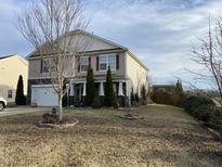 Charming two-story home featuring red shutters, manicured landscaping, and a welcoming front yard at 401 Lawton Dr, Haw River, NC 27258