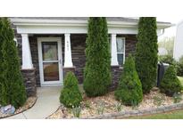 Charming front porch with stone accents and meticulously landscaped garden at 401 Lawton Dr, Haw River, NC 27258