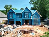 Under construction two-story home showing the framing and blue sheathing at 405 Latimer Rd, Raleigh, NC 27609