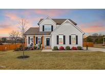 Charming two-story home with white siding, black shutters, and a well-manicured lawn at 4412 Beckel Rd, Willow Springs, NC 27592