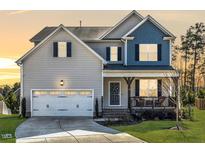Charming two-story home features a welcoming front porch and a two-car garage at 50 Dover Ridge Ct, Chapel Hill, NC 27517
