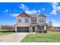 Charming two-story home featuring two-tone paint, a two-car garage, and a well-manicured front yard at 500 Wakefield Dr, Princeton, NC 27569
