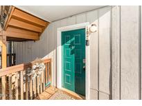 Inviting teal front door with security features and unit number displayed above the door at 5816 Pointer Dr # 102, Raleigh, NC 27609