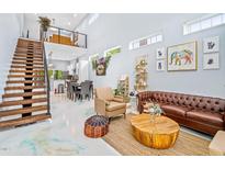 Inviting living room boasts an open staircase, high ceilings, and stylish decor at 601 Lee St, Durham, NC 27701