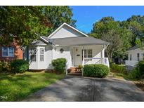 Charming one story home with a cozy front porch, lovely landscaping, and a private driveway at 646 W Club Blvd, Durham, NC 27701