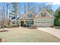 Charming two-story home featuring a manicured lawn, stone accents, and a welcoming two-car garage at 86 Pappy Ln, Garner, NC 27529