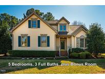 Charming two-story home with blue shutters and a well-manicured front lawn at 8600 Paddle Wheel Dr, Raleigh, NC 27615
