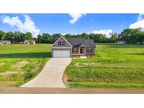Beautiful single-Gathering home with an attached garage on a lush green lawn and a curving concrete driveway at 9315 Turkey Way, Middlesex, NC 27557