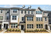 Attractive brick and siding exterior featuring dormer windows and stylish architectural elements at 983 Parkstone Towne Blvd, Knightdale, NC 27545