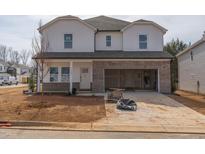 Two-story home featuring white siding, brick accents, and an attached two-car garage at 1720 Pie Filling Dr, Haw River, NC 27258