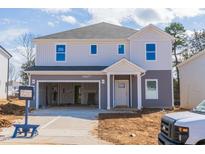 New two-story home featuring gray and white siding, an attached two-car garage, and a covered front entry at 1730 Pie Filling Dr, Haw River, NC 27258