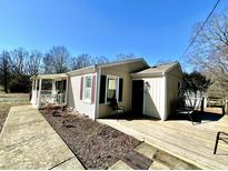 Charming single-story home featuring a welcoming front porch, well-maintained lawn, and inviting curb appeal at 2001 S Ashland Dr, Burlington, NC 27217