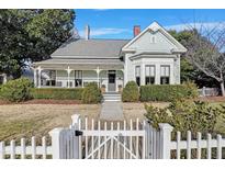 Charming home features a beautiful yard, white picket fence, covered porch, and bay window for curb appeal at 206 S Salem St, Apex, NC 27502