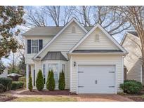 Charming two-story home with cream siding, bay window and well-manicured landscaping at 2728 Cherry Field Dr, Raleigh, NC 27603