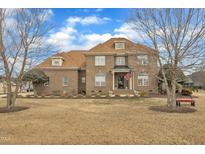Charming brick two-story home with landscaped yard and an inviting front porch perfect for relaxing at 296 Shoreline Dr, Princeton, NC 27569