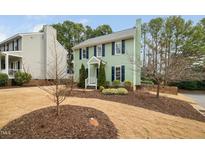 Charming two-story home featuring a well-manicured lawn and lush greenery at 3304 Glen Currin Dr, Raleigh, NC 27612