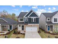 Charming two-story home with a stone facade and well-manicured front yard at 44 Fairwinds Drive Dr, Lillington, NC 27546