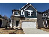 Charming two-story home featuring stone accents, a two-car garage, and manicured landscaping at 44 Fairwinds Drive Dr, Lillington, NC 27546