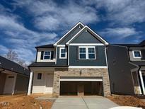 Two-story home featuring stone accents, complementary siding, and a two-car garage at 44 Fairwinds Drive Dr, Lillington, NC 27546
