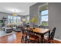 Bright living room with comfortable seating, dining area, and large windows with cityscape views at 506 N Mangum St # 303, Durham, NC 27701