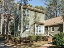 Charming two-story home with an exterior showcasing lush landscaping and lots of windows for natural light at 5917 Sentinel Dr, Raleigh, NC 27609