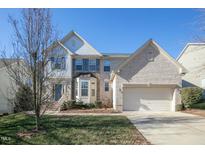 Charming two-story home with a brick facade, well-manicured lawn, and an attached two-car garage at 708 Barley Green St, Wake Forest, NC 27587