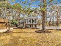 Charming two-story home with gray siding, brick foundation, black shutters, and a well-maintained front yard at 1041 Limerick Ln, Durham, NC 27713
