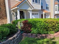 Charming townhome featuring a stone and siding exterior with a covered front porch at 11843 Canemount St, Raleigh, NC 27614
