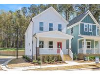 Charming two-story home featuring a welcoming front porch with a vibrant red door at 122 Weavers Grove Dr, Chapel Hill, NC 27514