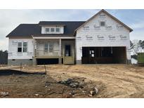 New two-story home under construction with a porch and attached garage at 18 Golden View Pl, Zebulon, NC 27597