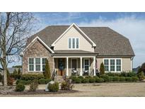 Charming two-story home with stone accents, covered porch, manicured landscaping, and a welcoming entrance at 2609 Packhouse Rd, Zebulon, NC 27597